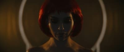 a woman with red hair and a ring around her neck