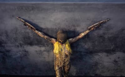a woman with her arms spread out in front of a wall