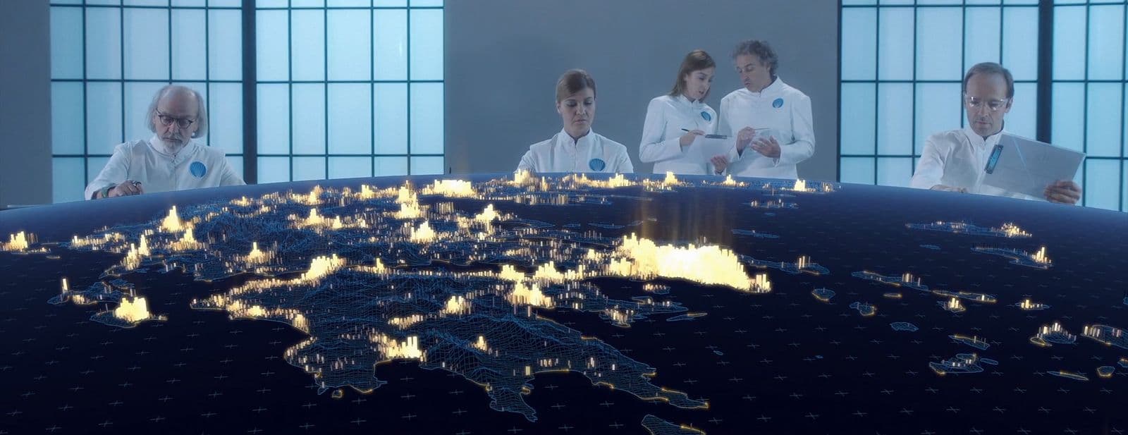 a group of people standing around a world map