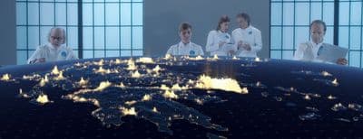 a group of people standing around a world map