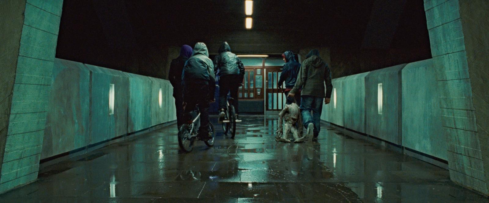 a group of people riding bikes down a hallway