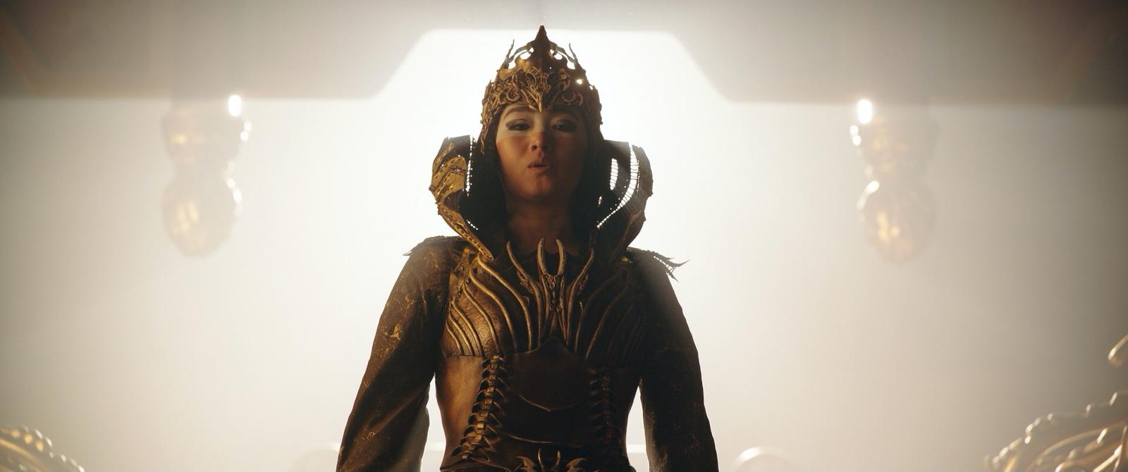 a woman in a costume standing in front of a light