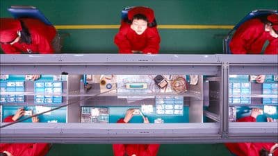 a group of people dressed in red standing in front of a display case