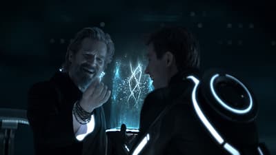 a man standing next to another man in a dark room