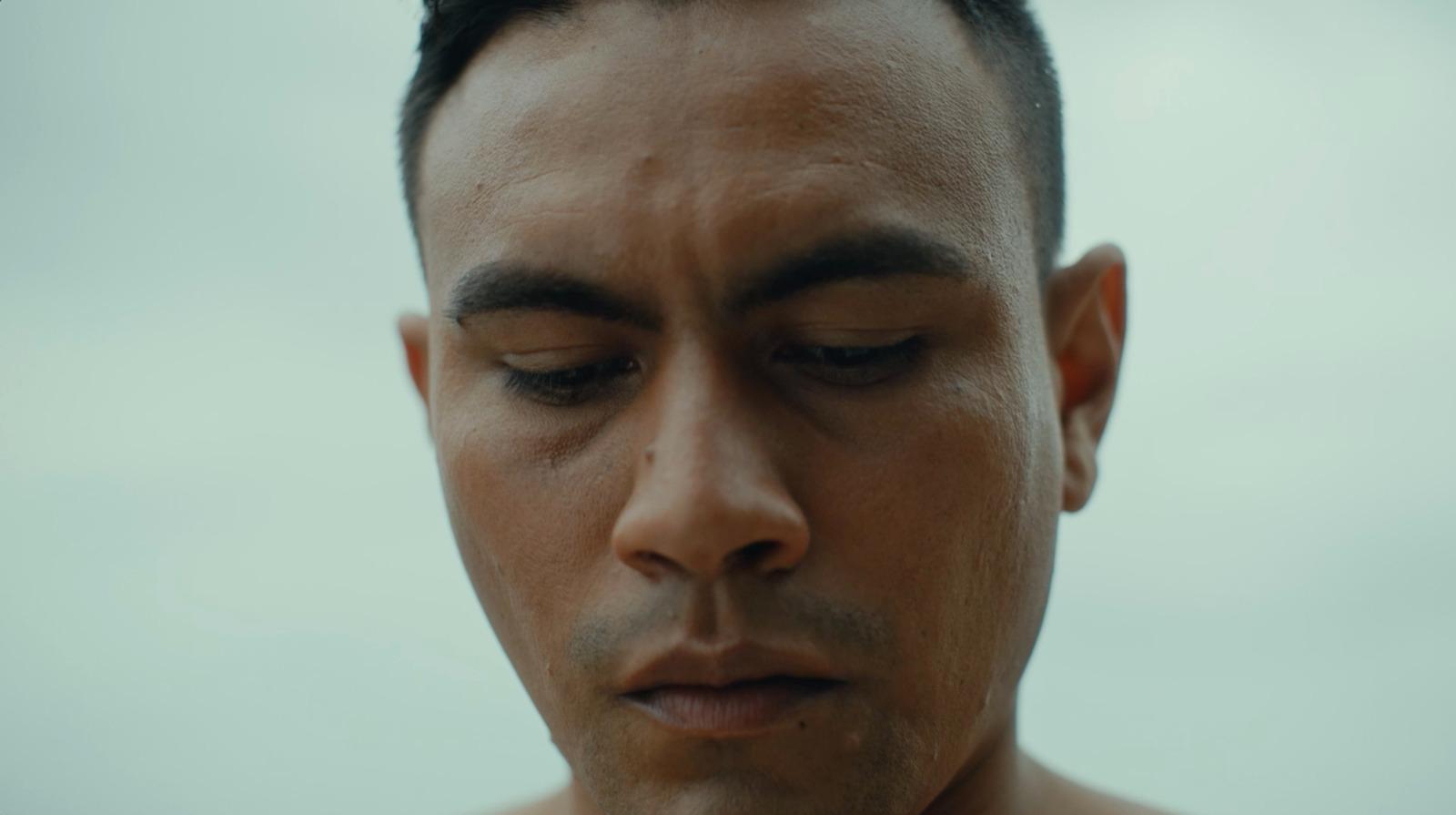 a close up of a man with his eyes closed