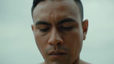 a close up of a man with his eyes closed