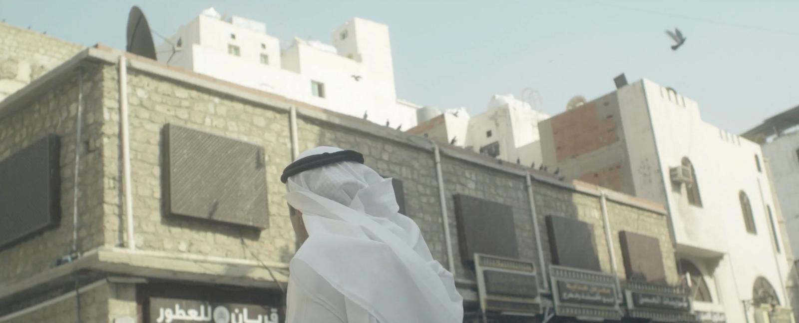 a person wearing a white veil standing in front of a building