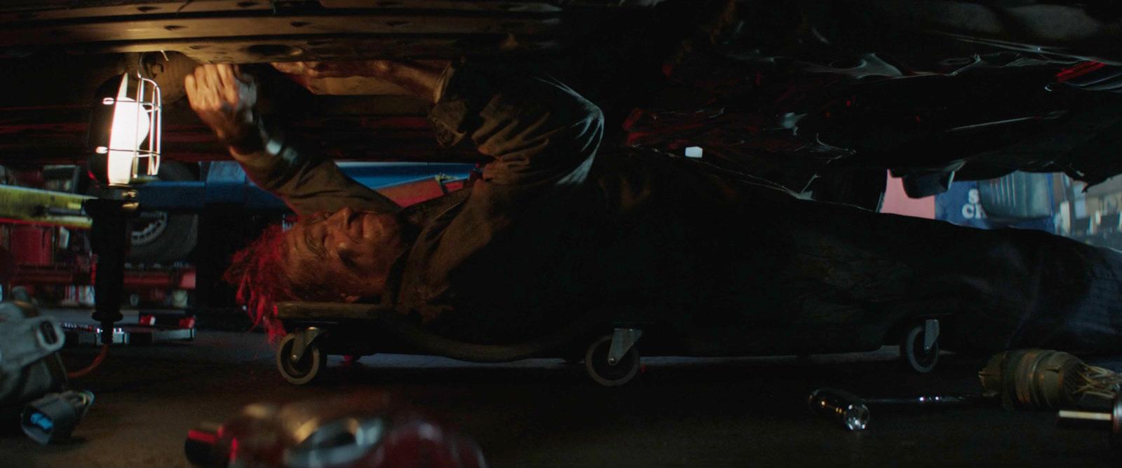 a person in a dark garage with a light on