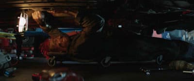 a person in a dark garage with a light on
