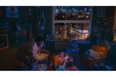 a group of people sitting around a living room