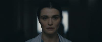 a woman with dark hair and a blue shirt