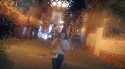 a blurry image of a person walking down a street