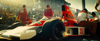 a man in a race car in front of a crowd