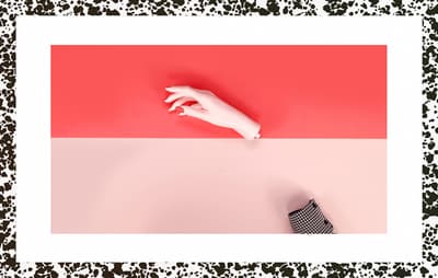 a person's hand on a red and pink background