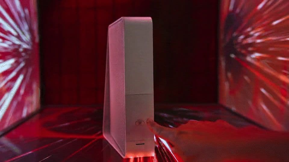 a person holding a white object in front of a red light