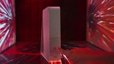 a person holding a white object in front of a red light