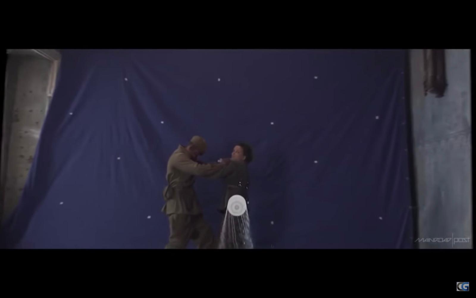 two people standing in front of a blue wall