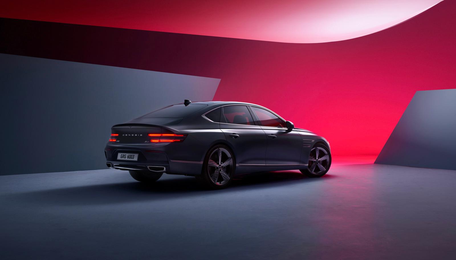 a black car parked in a room with a red wall