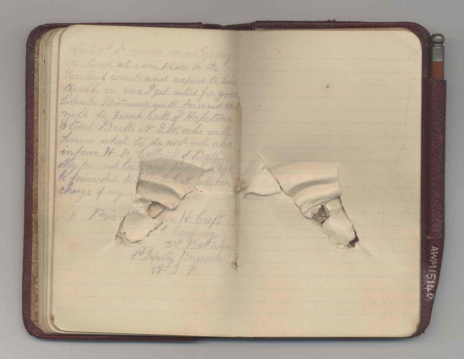 an open notebook with a torn piece of paper