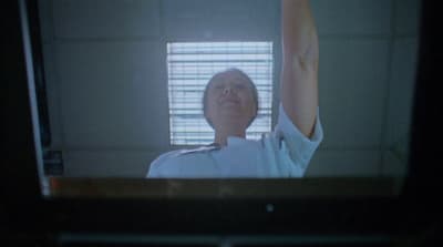 a woman is holding her hand up in the air