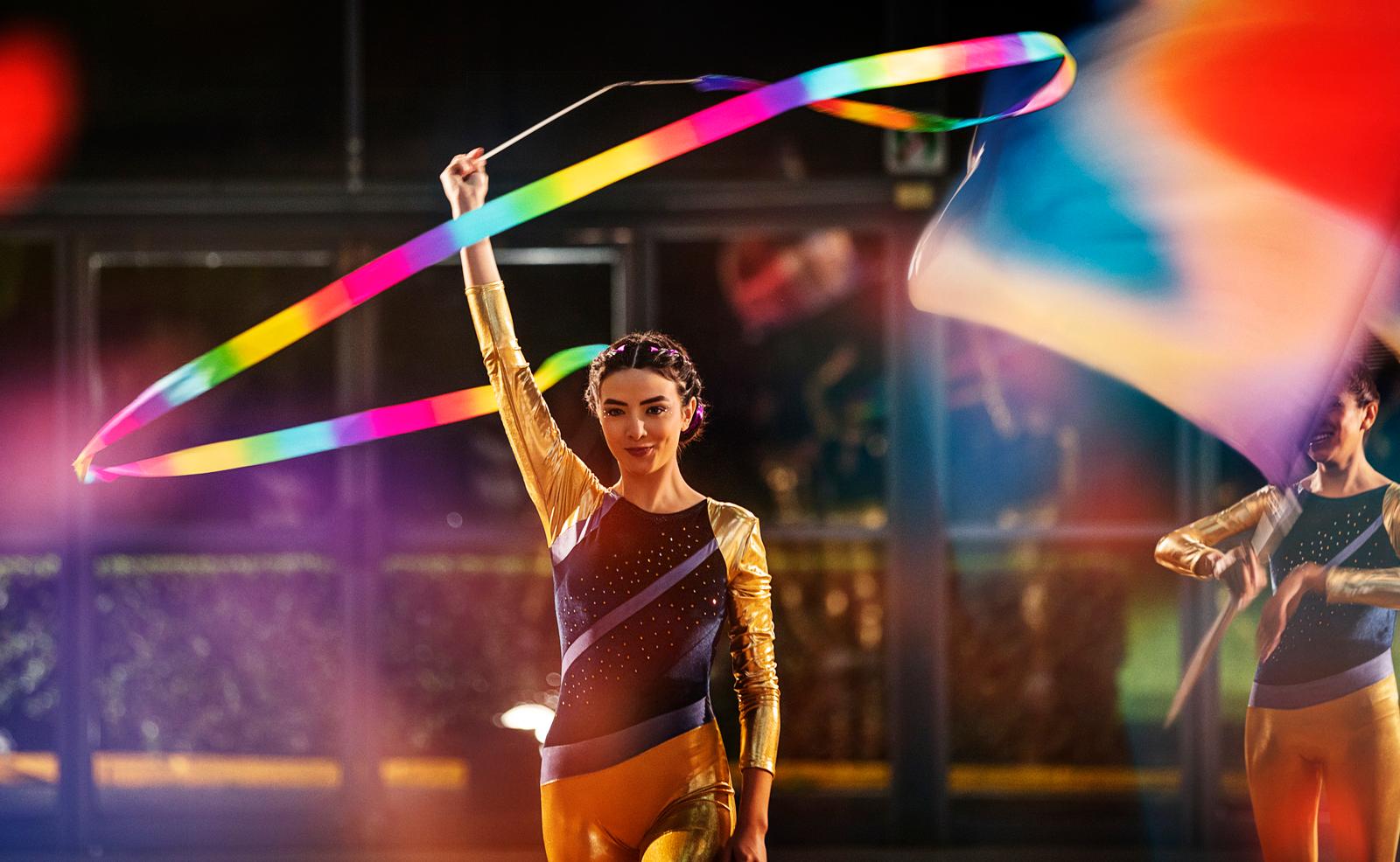 a couple of women holding a rainbow colored kite