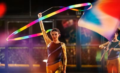 a couple of women holding a rainbow colored kite