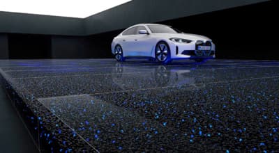 a white car parked in a dark room