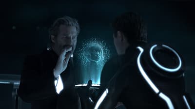 a man standing next to another man in a dark room