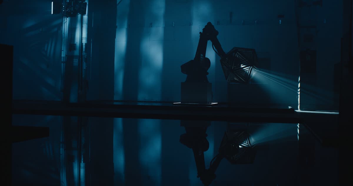 a dark room with a light shining through the window