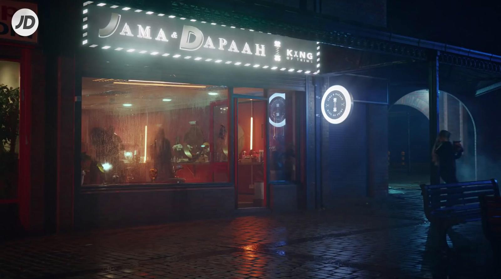 a person standing outside of a building at night