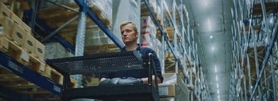 a man sitting on a chair in a warehouse