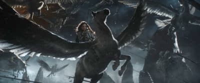 a man riding on the back of a dinosaur in a forest