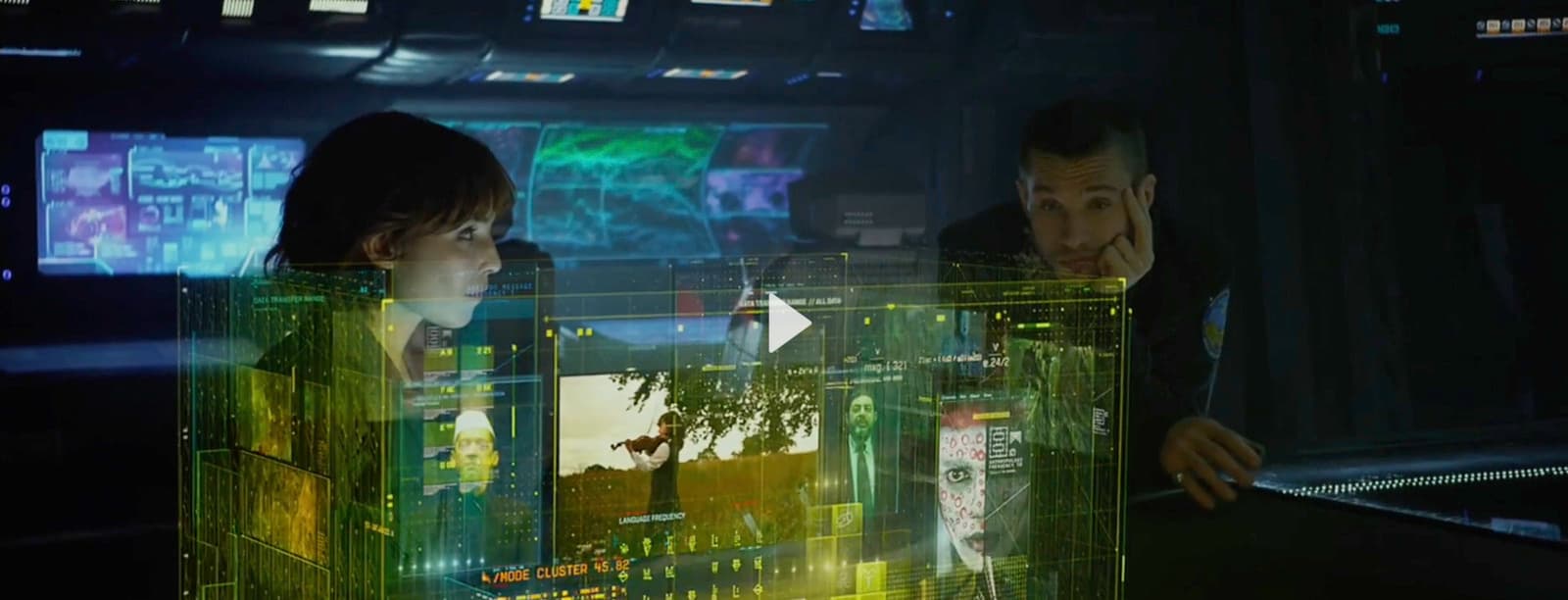 a man and a woman looking at a computer screen
