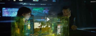 a man and a woman looking at a computer screen