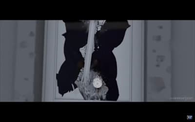 a black and white photo of a broken window