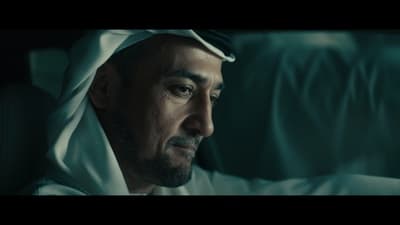 a man in a white robe is staring at something