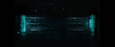 a dark picture of a gate in the middle of a body of water