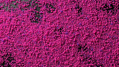 a lot of pink bubbles floating in the air