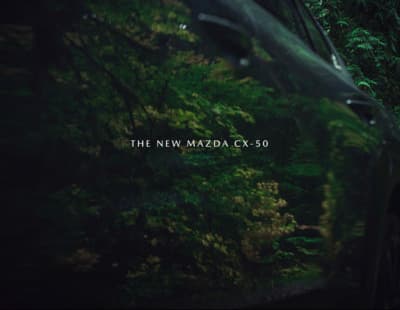 the new mazda cx - 50 is parked in the woods