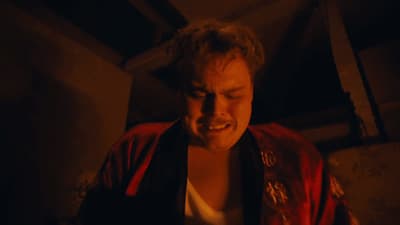 a man in a red jacket looking at a cell phone