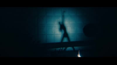 a shadow of a person standing in a dark room