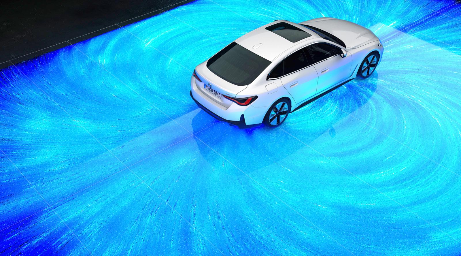 a white car driving on a blue carpet