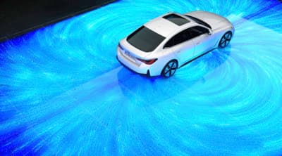 a white car driving on a blue carpet