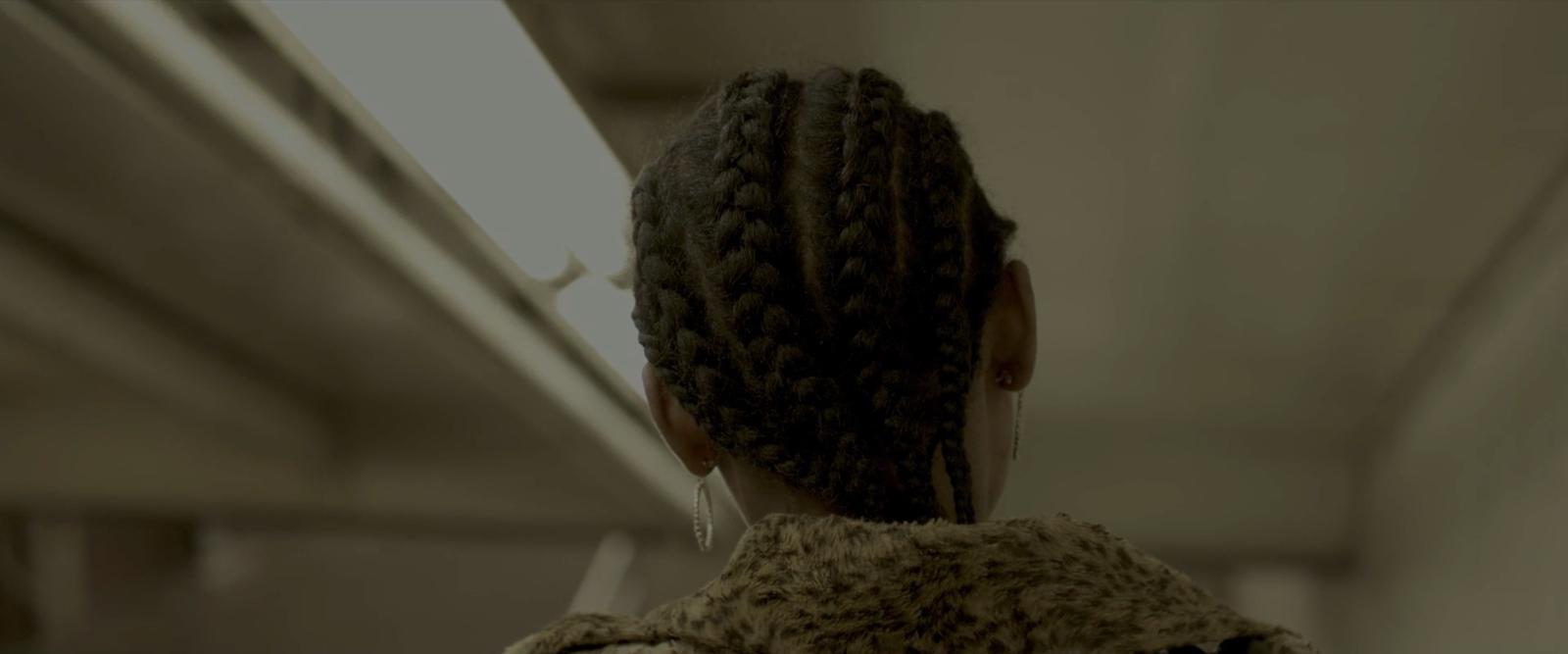 the back of a woman's head with braids