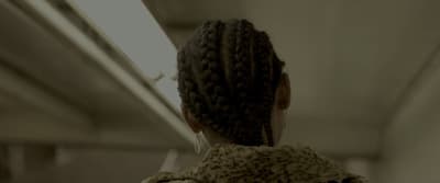 the back of a woman's head with braids