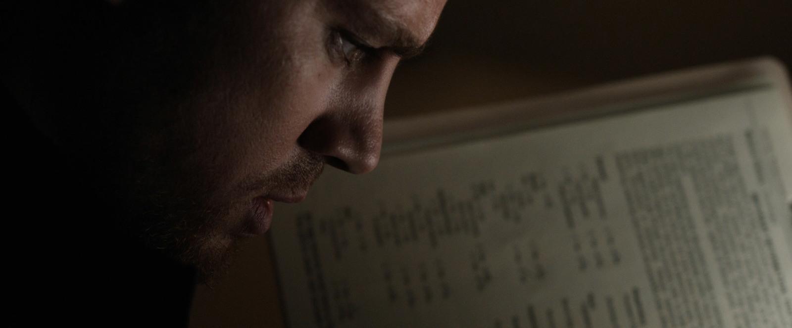 a close up of a person reading a book