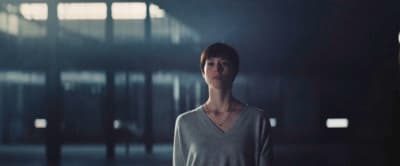 a woman standing in a dimly lit room