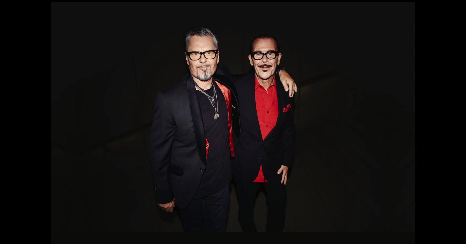 a couple of men standing next to each other