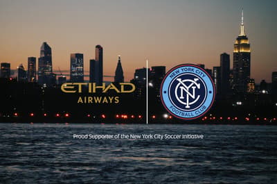 a picture of a city skyline with a sign for the new york city soccer club
