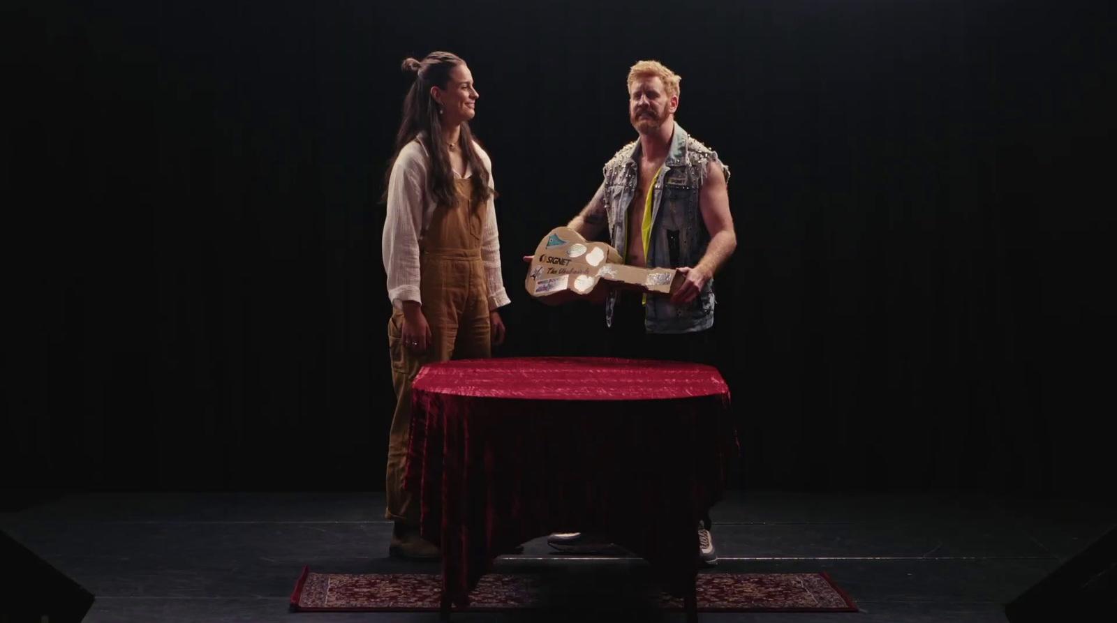 a man and a woman standing in front of a table